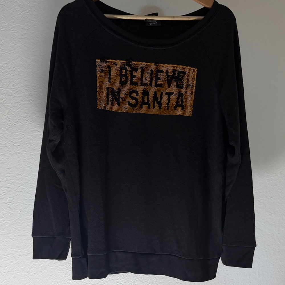 Black Sweatshirt with Gold 'I Believe in Santa' flips to ‘I believe in pizza’